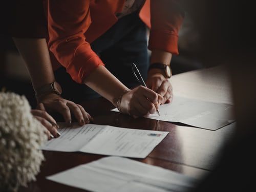 Entrepreneurs signing their company formation documents
